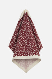 Floral-patterned towel folded neatly on a white background