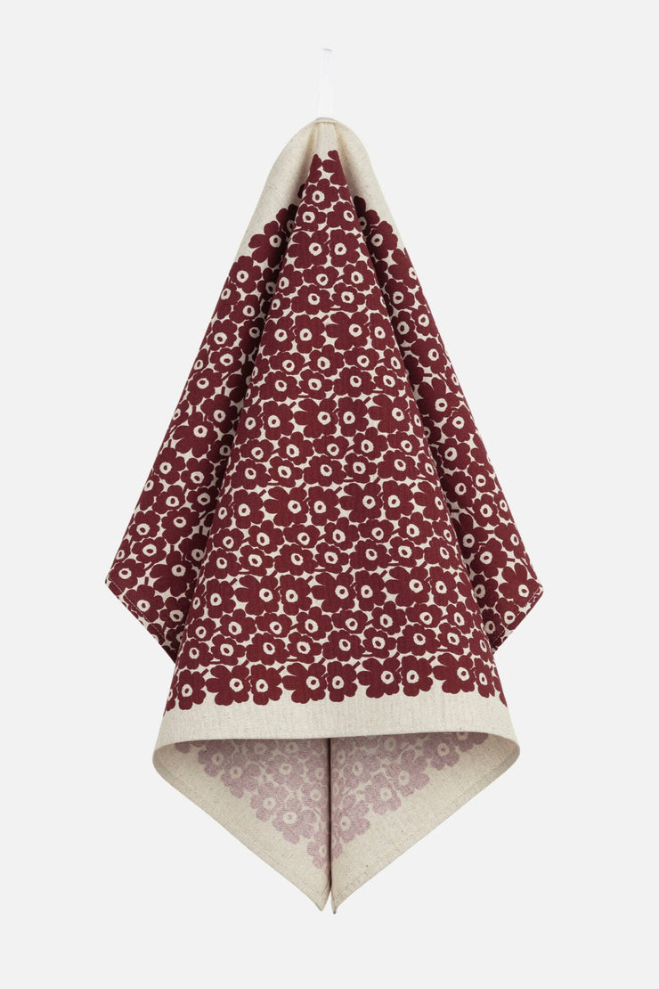 Floral-patterned towel folded neatly on a white background